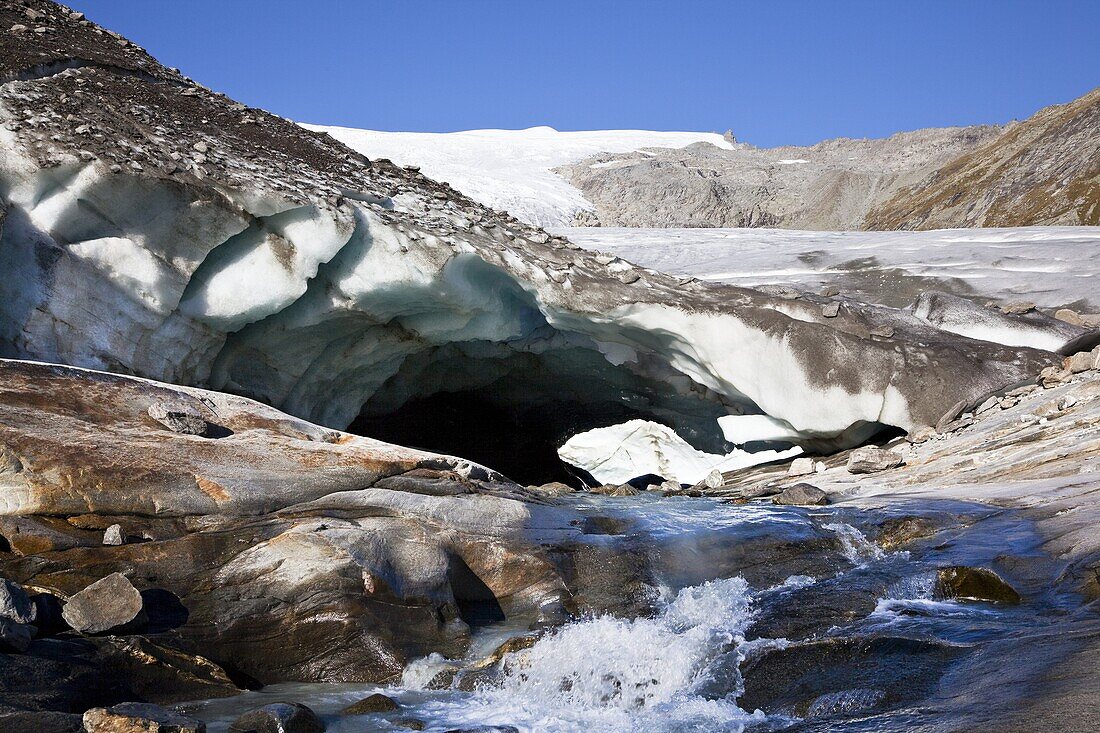 Ice cave and glacier snout of Schlatenkees, source of the creek Schlatenbach  parts of the have collapsed and melted away  Therefore an ice cave with two openings exists  The Schlatenkees is one of the biggest glaciers in Austria and retreating rapidly  G