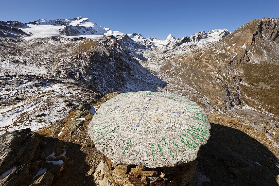 The upper valley martelltal Butzental with the Mts Zufallspitzen and Koenigsspitze Mount Zebru in fall  A table made from rock with engravings of the names of and directions to the mountains, valleys and villages in the foreground  Europe, central europe