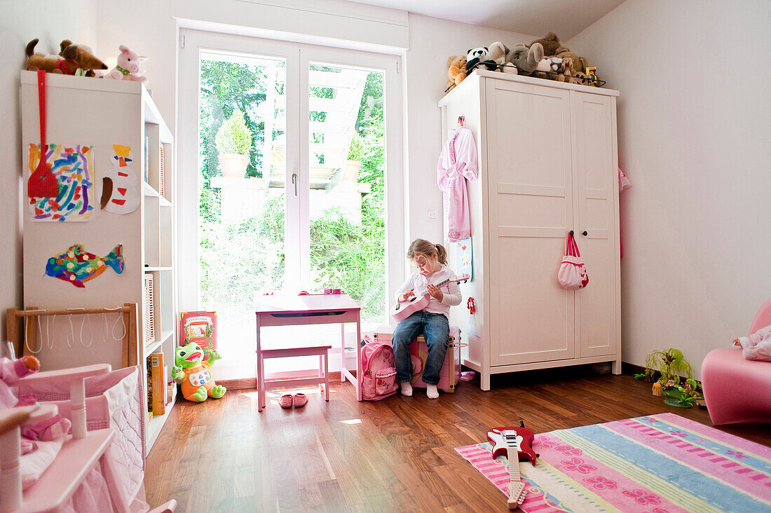 Girl playing in child's room, Hamburg, Germany