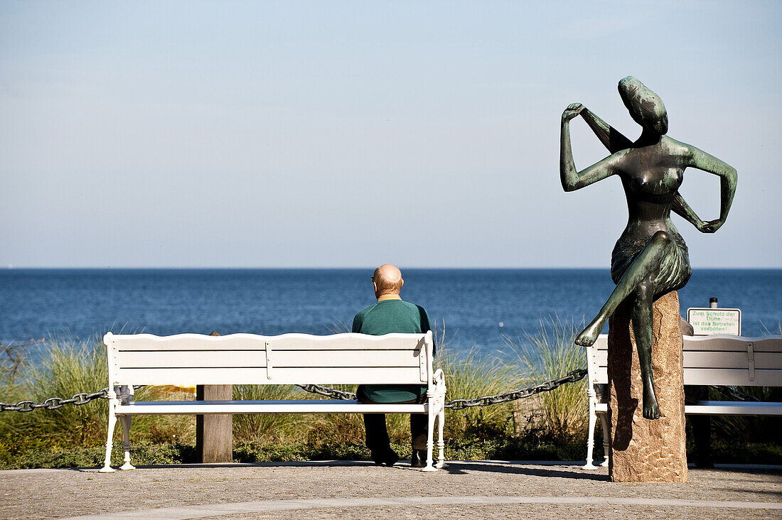 Man sitting on a bank while looking at view, Timmendorfer Strand, Schleswig-Holstein, Germany