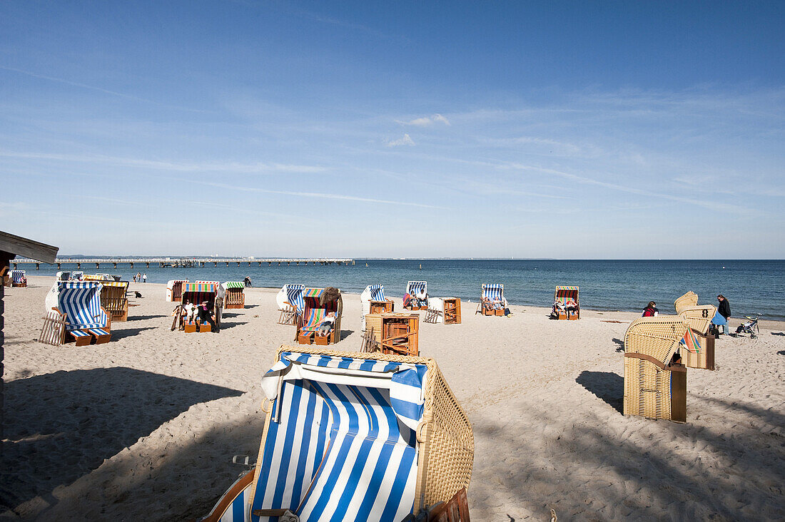 Roofed wicker beach chairs at beach, Timmendorfer Strand, Schleswig-Holstein, Germany