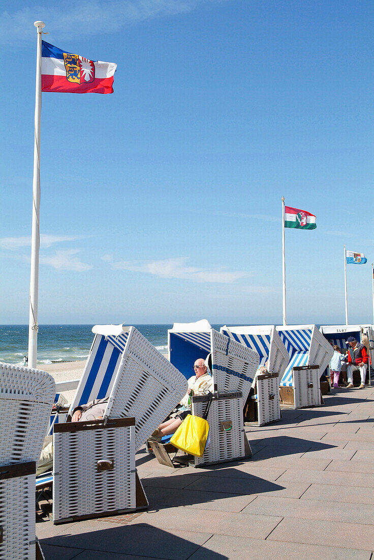 Roofed wicker beach chairs at beach, Westerland, Sylt island, Schleswig-Holstein, Germany