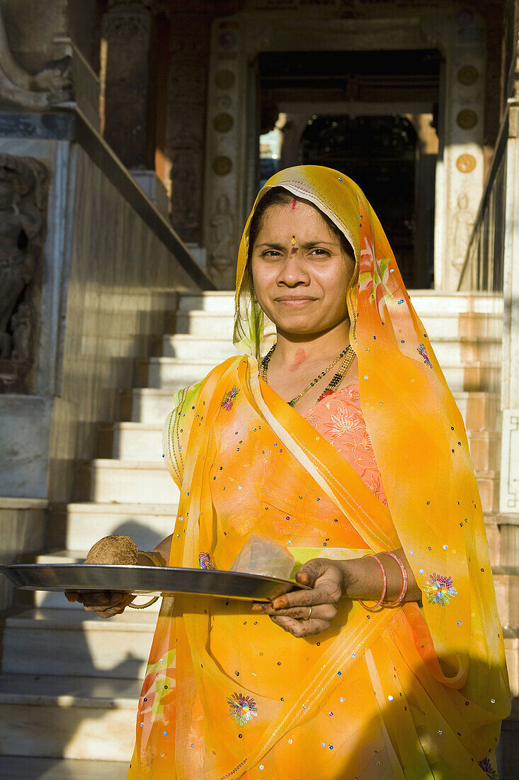Female worshipper holding offering tray, at Sachiya Mata Temple, Osian, near Jodhpur, Rajasthan, India