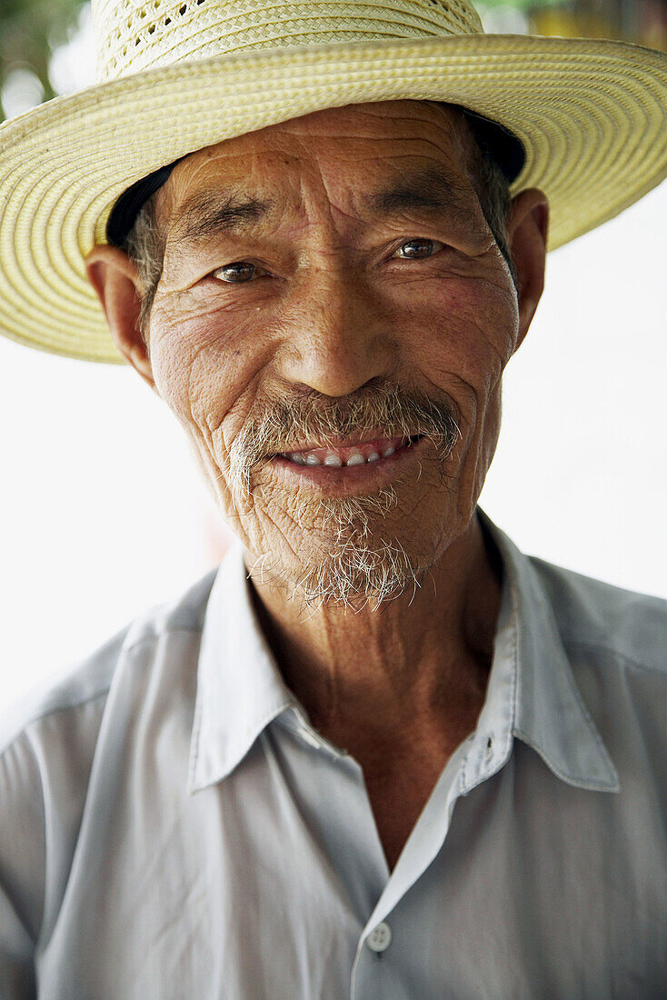 Adult, Adults, Asia, asian, Asian ethnicity, asians, China, Color, Colour, Daytime, Ethnic, Ethnicity, exterior, Facing camera, Gansu, Goatee, Goatees, grin, grinning, Hat, Hats, Head & shoulders, Head and shoulders, Headgear, headshot, headshots, human, 