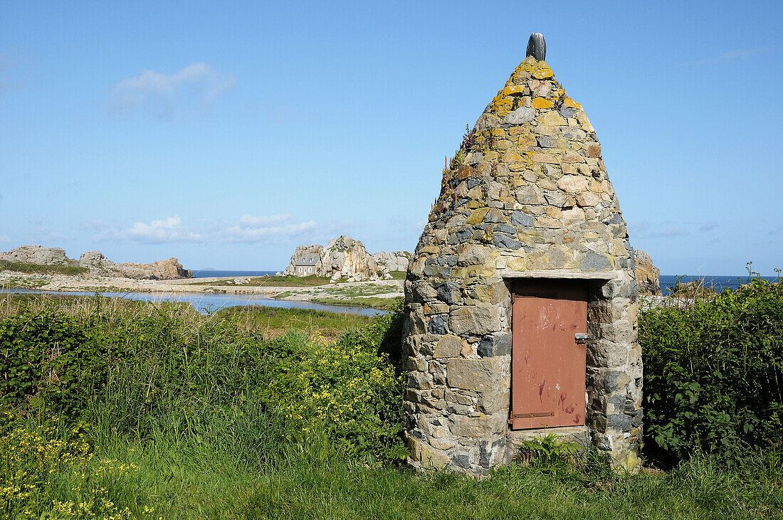 France, Brittany, Plougrescant 22  Shelter at Castel Meur near Le Gouffre, and coastal house in the background