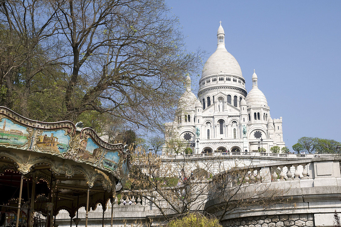 France, Paris 75  Basilique du Sacré-Coeur in Montmartre, with merry-go-round in the foreground