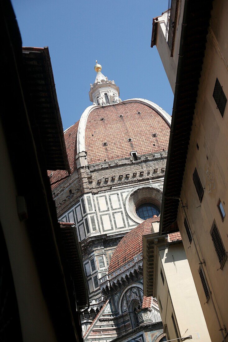 The Duomo in the Tuscan city of Florence or Firenze in Italy seen between two buildings