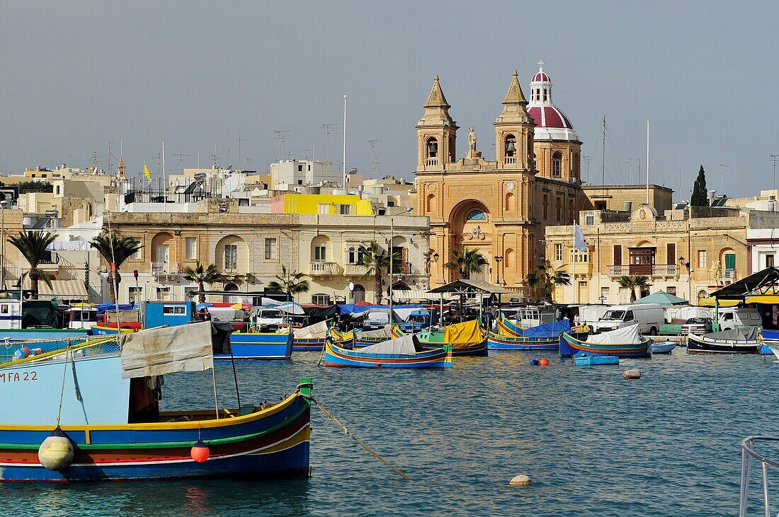 Marsaxlokk harbour and the church dedicated to our Lady of the Rosary The Madonna of Pompeii, Malta, Europe, november 2009