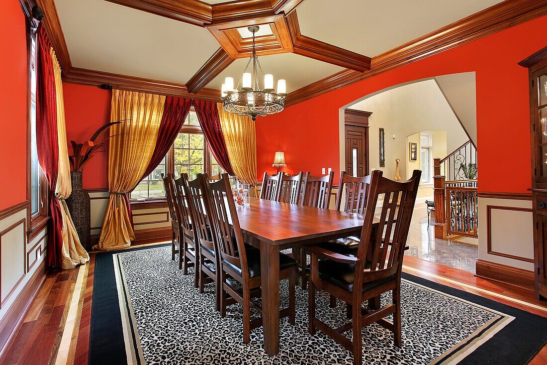 Traditional dining room in suburban home with red walls