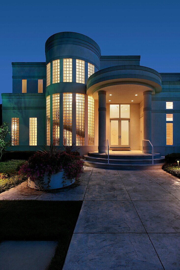 Luxury home at dusk with column entry