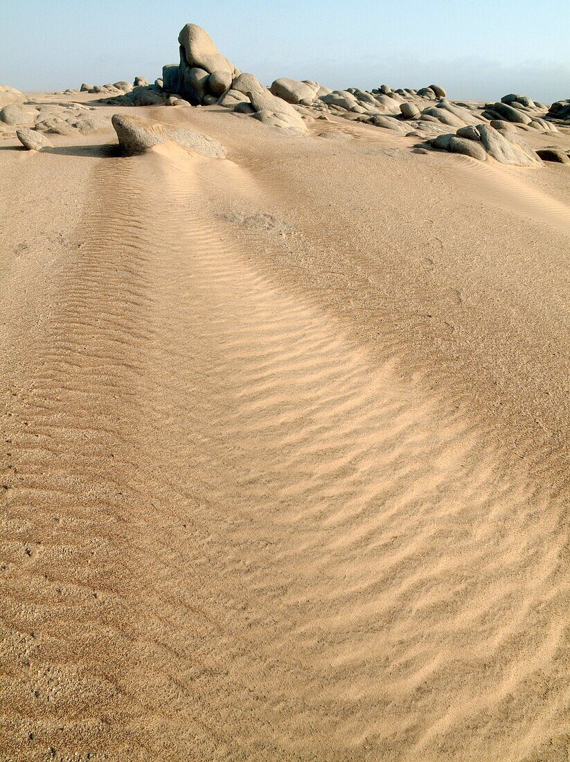 Namibia - Grey-white rocks in the sand of the Namib Desert near Torra Bay Skeleton Coast Park, Namibia