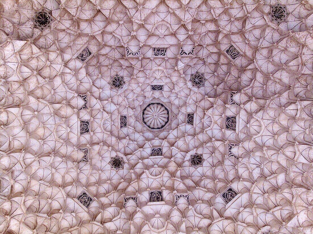 Morocco - Highly elaborated stuccowork at a roof at the entrance to the Ben Youssef Medersa teaching annexe to the old mosque universities, one of the finest buldings in Marrakesh