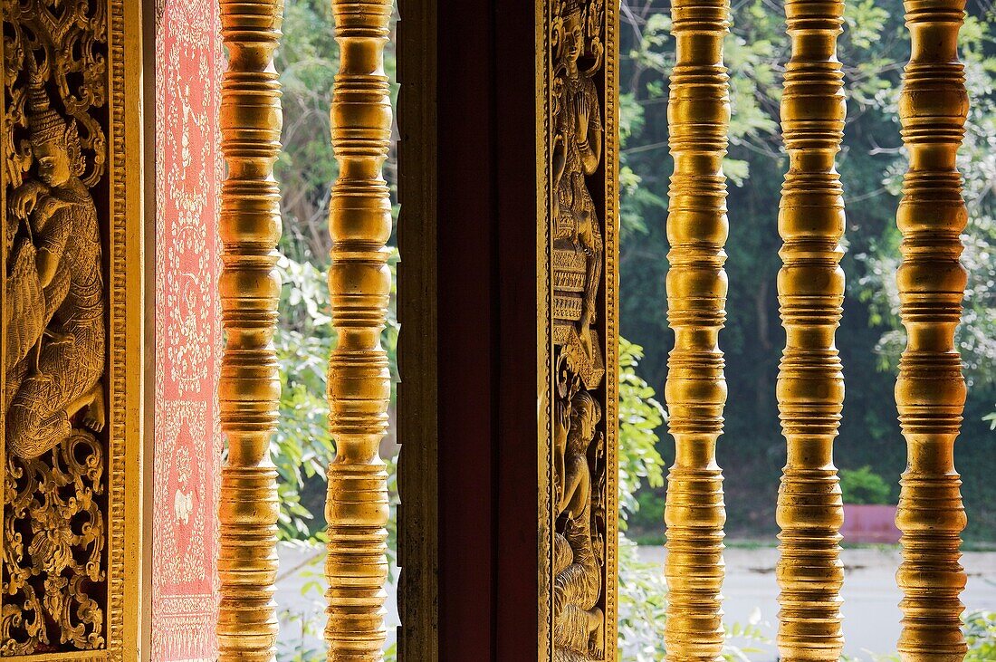 Laos - Window with colonettes in the magnificent Pra Bang Pavilion which houses Pra Bang, the standing Buddha image that gives Luang Prabang its name In 1995 Luang Prabang was declared UNESCO World Heritage Site in recognition of its elaborately decorate