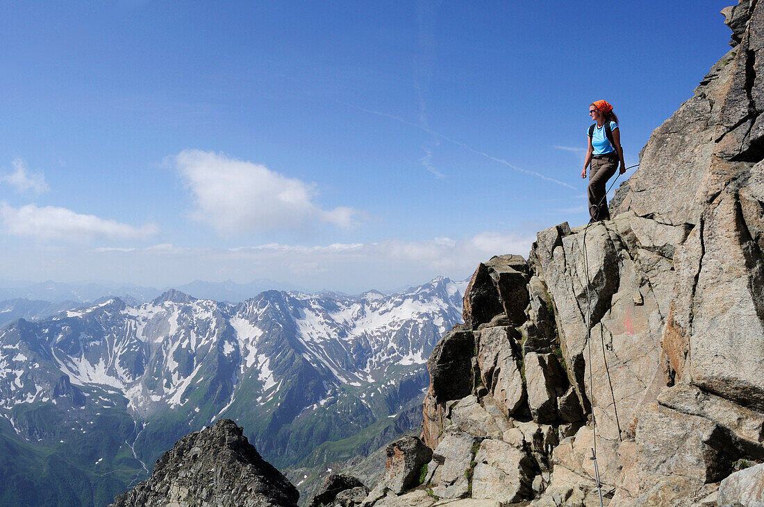 Woman enjoying view from mount Habicht, Gschnitz valley, Stubai Alps, Tyrol, Austria