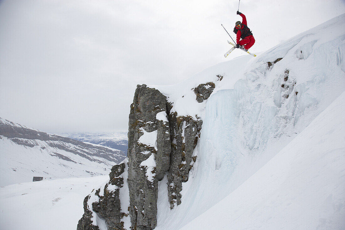 Skier jumping over rock, Flims, Canton of Grisons, Switzerland