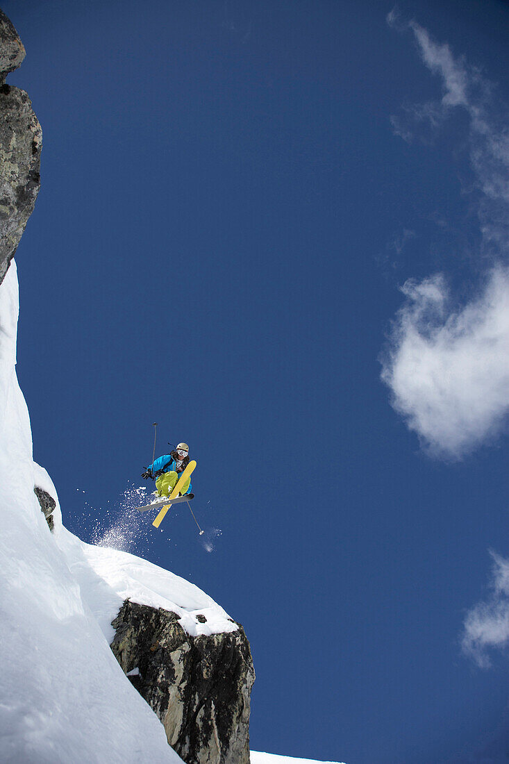 Skier jumping over rock, Disentis, Oberalp pass, Canton of Grisons, Switzerland