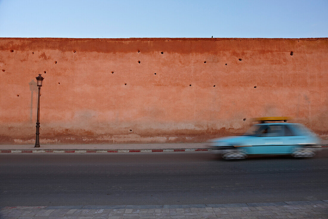 Taxi in front of mud wall,  Meknes, Morocco, Africa
