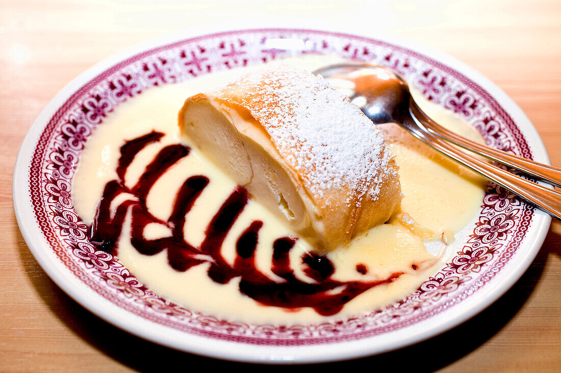 Typical dessert called Topfenstrudel served with vanilla sauce, Tappenkarsee Hut, Salzburger Land, Austria
