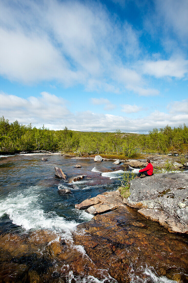 Hiker at Lakktajåkko river, Lapland, northern Sweden, Sweden