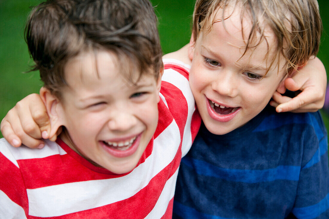 Two boys (6 - 7 years) pulling ears each other