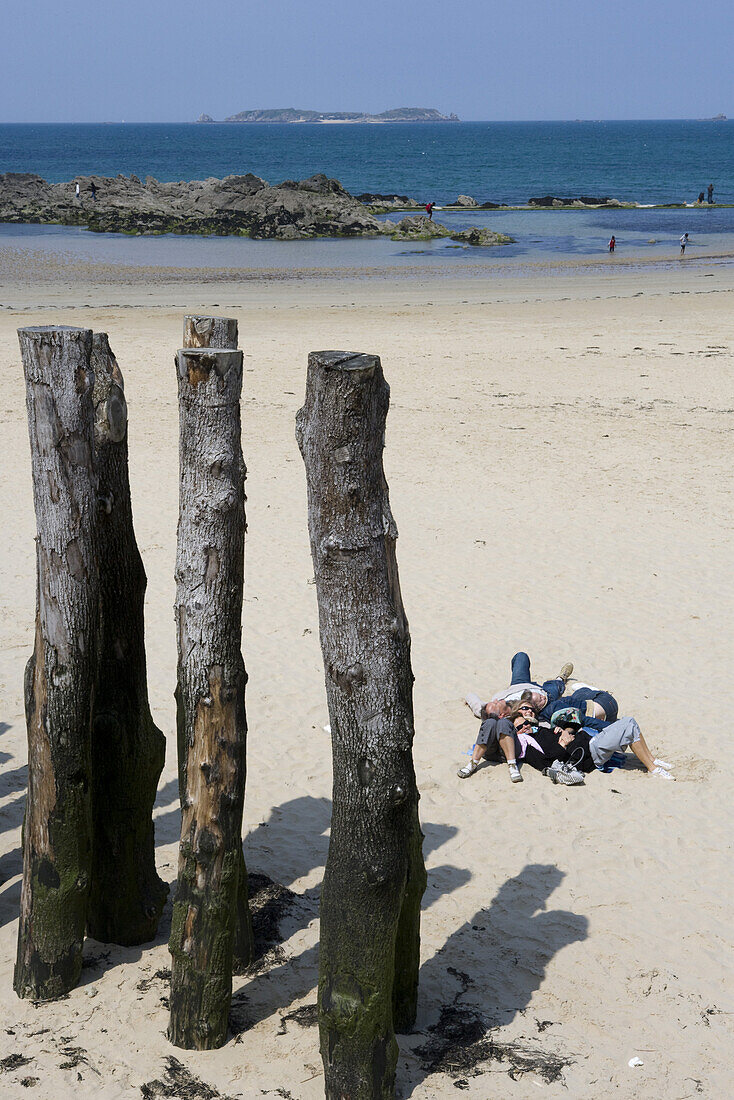 People snuggle up on beach, St. Malo, Brittany, France, Europe
