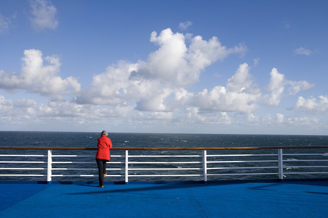 Passenger on deck of cruiseship MS Princess Daphne, North Sea, Europe