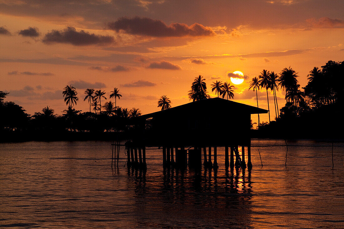 Sunset and fishermen hut at the westcoast of Koh Chang Island, Trat Province, Thailand, Asia