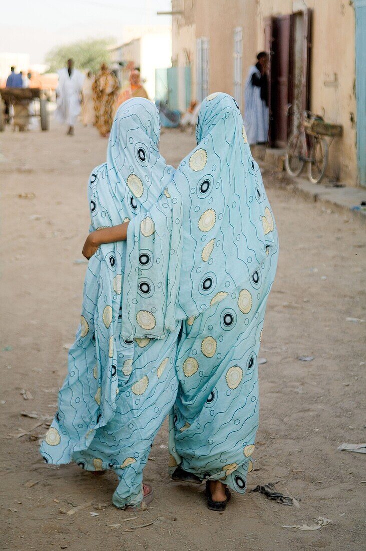 Young girls walking in the street, Atar town, Sahara desert, Mauritania