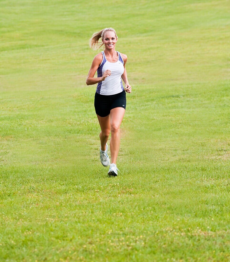 30 year old blonde woman jogging in work out clothes