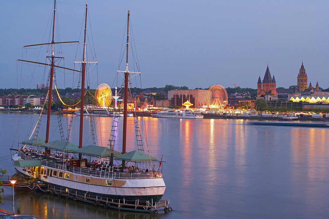 Restaurant ship on river Rhine, funfair and Mainz Cathedral in background, Mainz, Rheinhessen, Rhineland-Palatinate, Germany