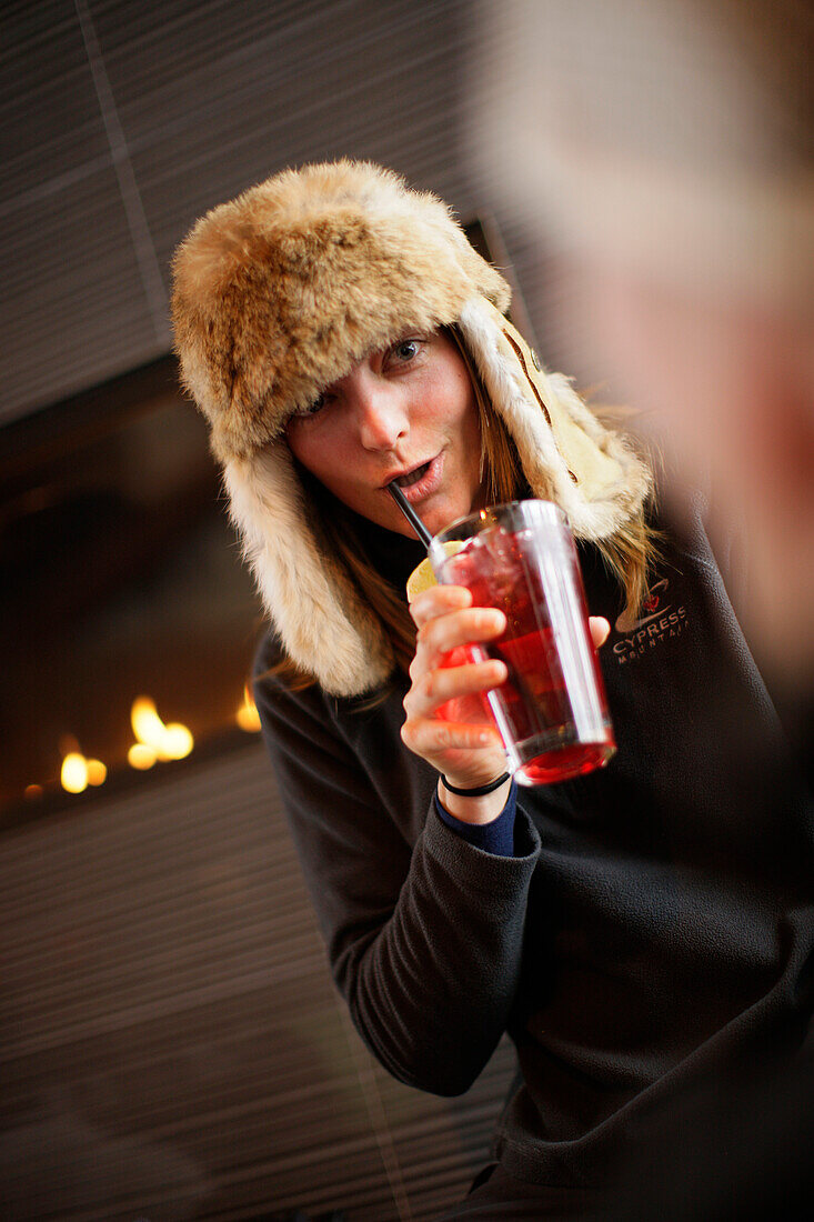 Woman with a drink in Cypress Creek Day Lodge, Cypress Provincial Park, British Columbia, Canada