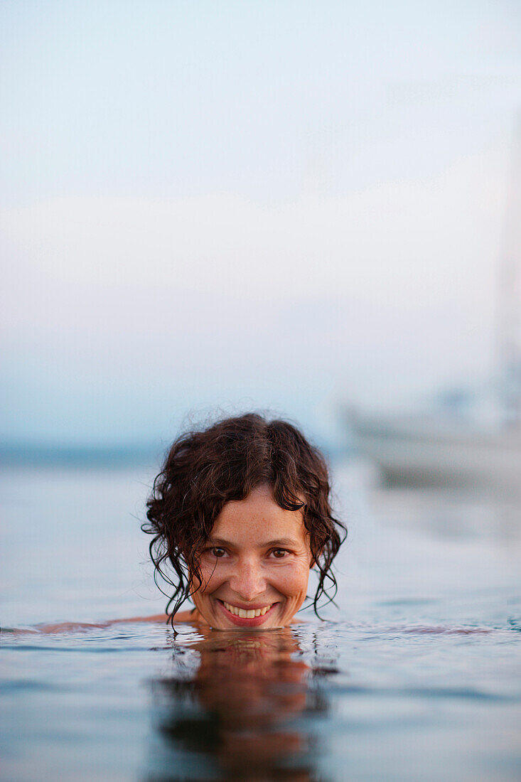 Woman bathing in lake Starnberg, Ambach, Munsing, Bavaria, Germany