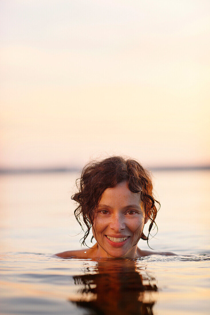 Woman bathing in lake Starnberg, Ambach, Munsing, Bavaria, Germany