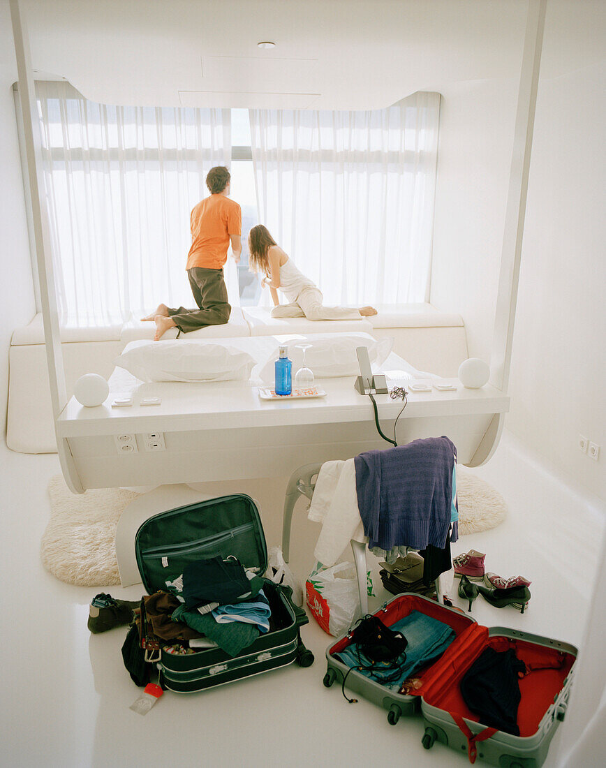 Couple in a hotel room, suitcases in foreground, Madrid, Spain