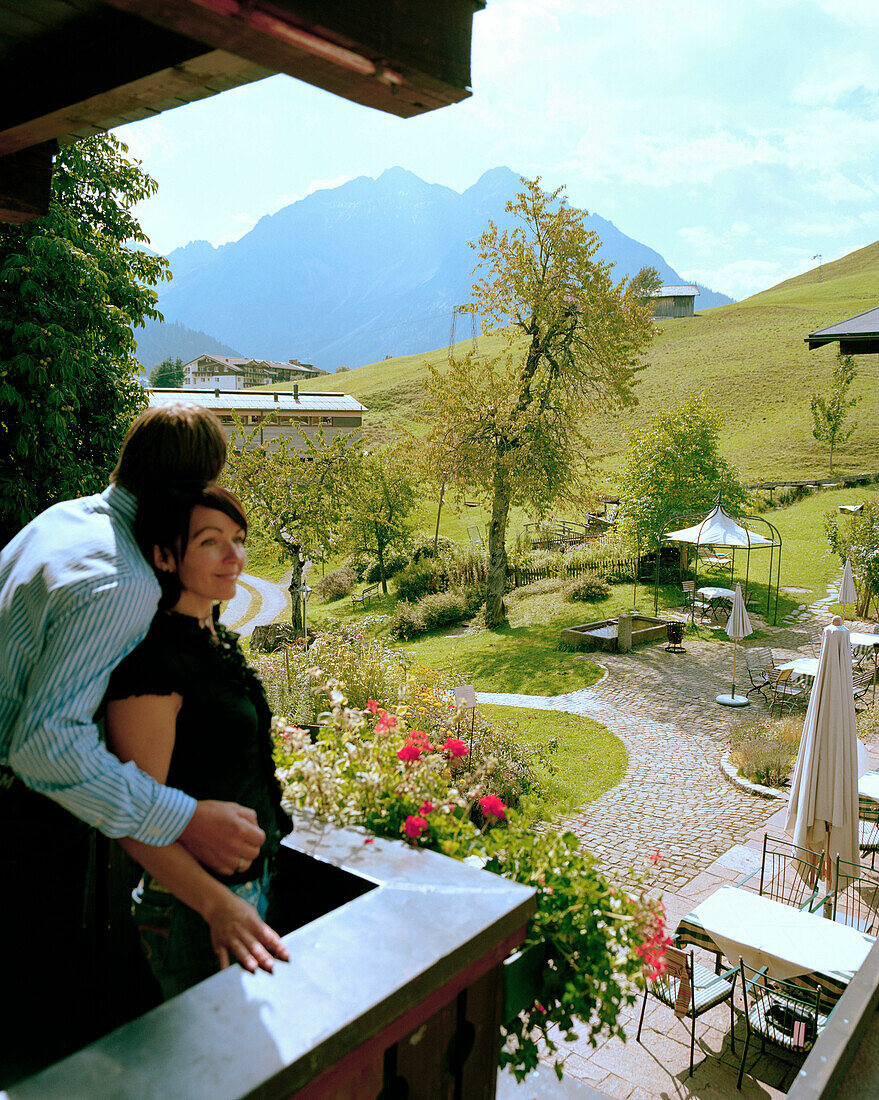 Couple on the balcony of an organic Hotel, Hirschegg, Kleinwalsertal, Styria, Austria