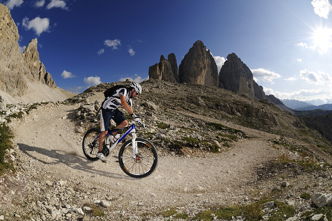 Cyclist Roland Stauder in front of the Drei Zinnen, Hochpuster valley, South Tyrol, Dolomites, Italy, Europe