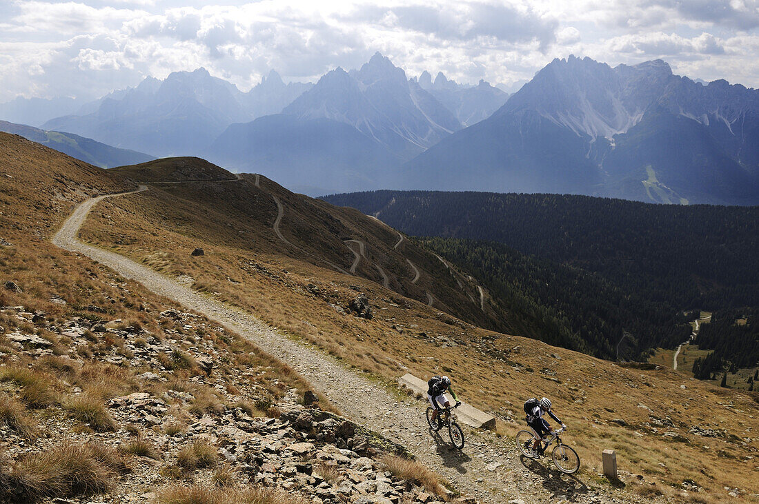 People on mountain bikes at ascent to Markinkele, Innichen, Hochpuster valley, South Tyrol, Dolomites, Italy, Europe