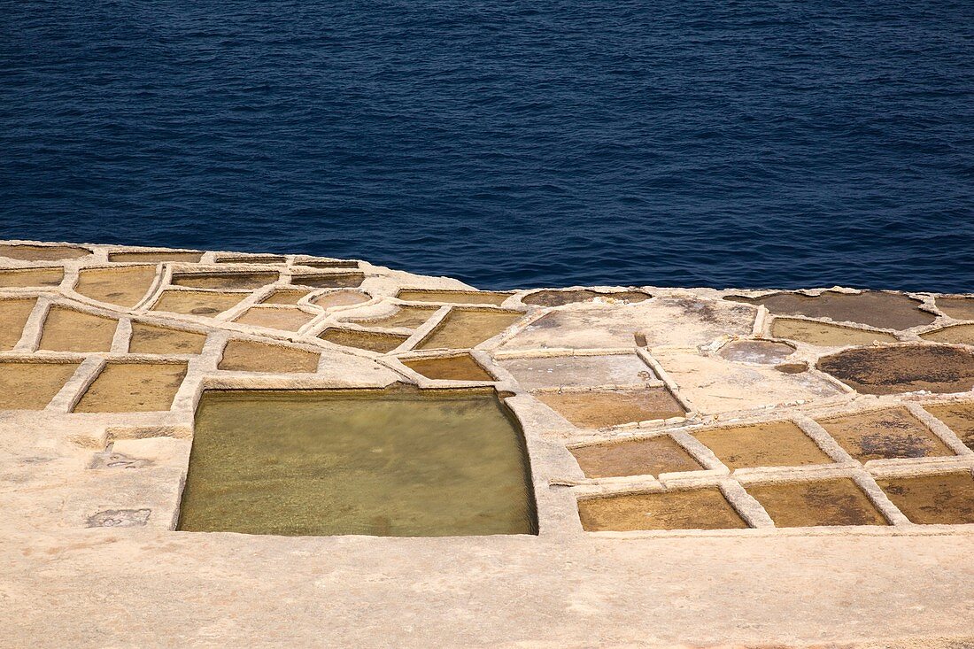 Malta, Gozo Island, Marsalform, salt pans carved into rocky coastline