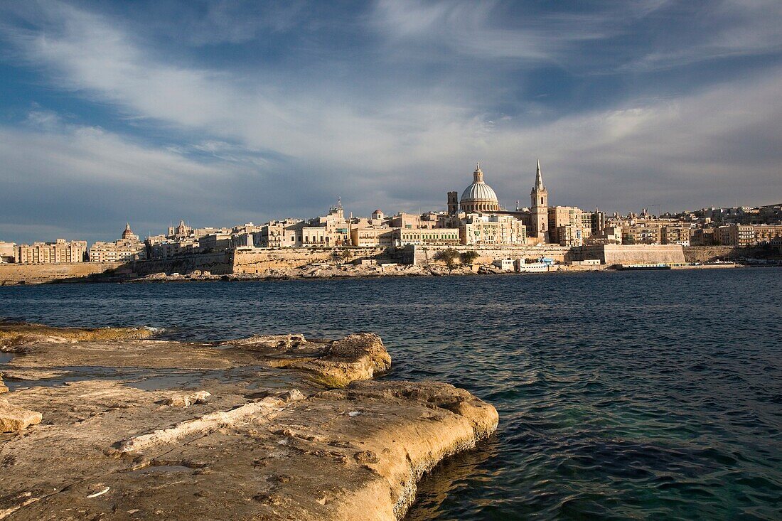 Malta, Valletta, skyline with St Paul's Anglican Cathedral and Carmelite Church from Sliema, sunset