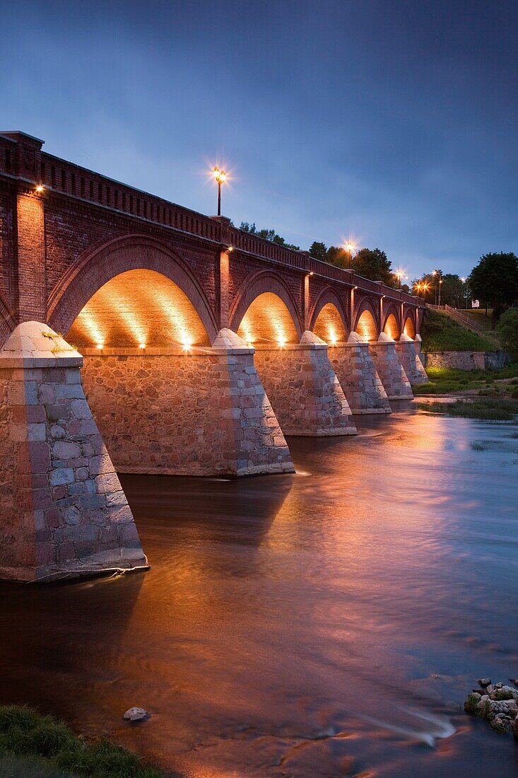 Latvia, Western Latvia, Kurzeme Region, Kuldiga, bridge over the Venta River by the Ventas Rumba, Kuldiga Waterfall, Europe's widest falls, width 275 meters, evening