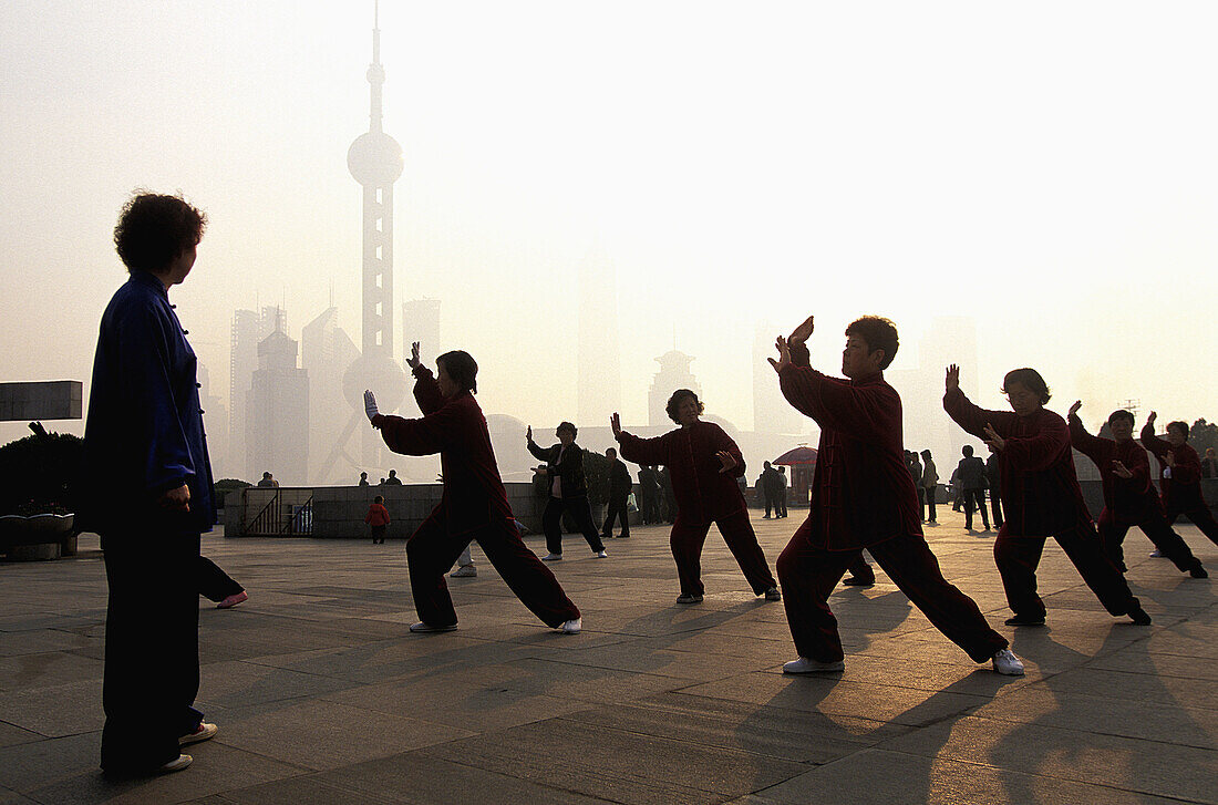 Early morning tai chi exercises on the Bund, Shanghai, China