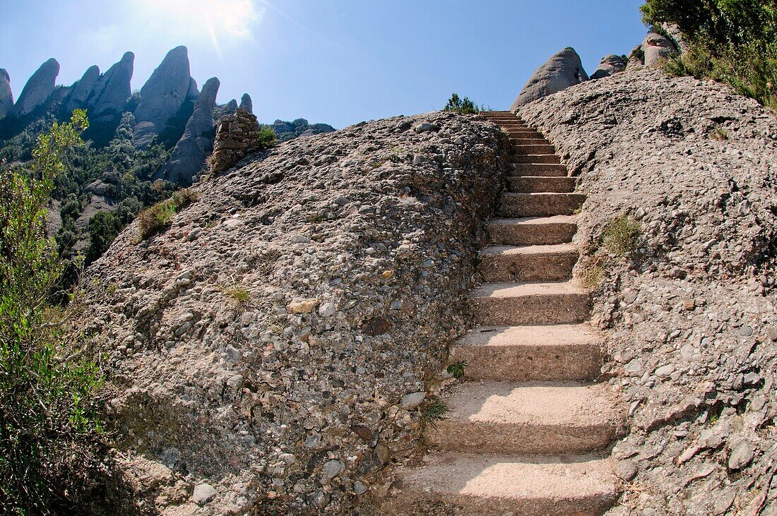 Stairs carved in agglomerate rock in hiking trail in characteristic landscape of the Montserrat mountain, Catalonia, Spain