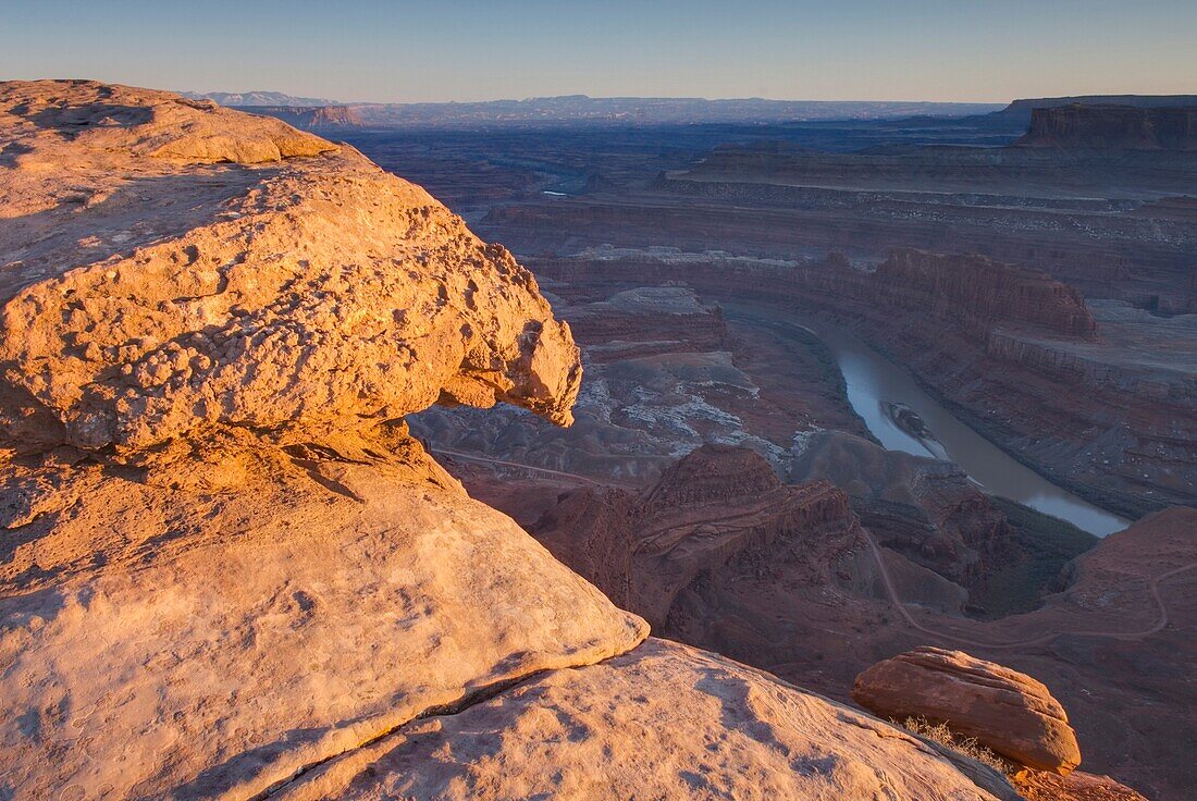View down to the Colorado River at sunset from overlook at Dead Horse Point State Park Utah