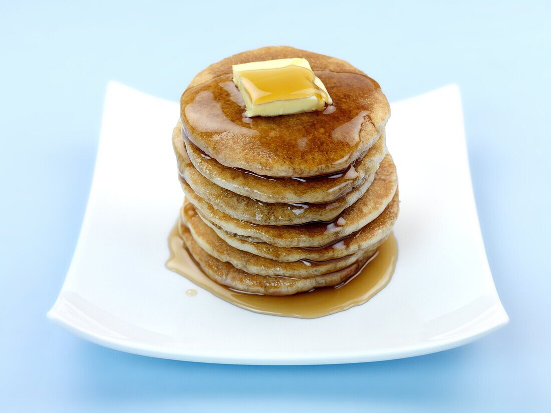 Fresh pancakes isolated against a blue background