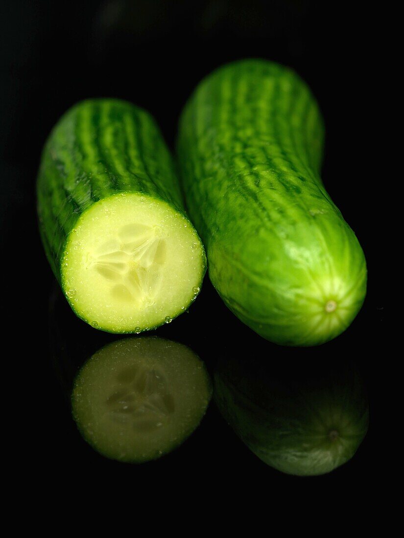 Lebanese cucumbers isolated against a black bacground