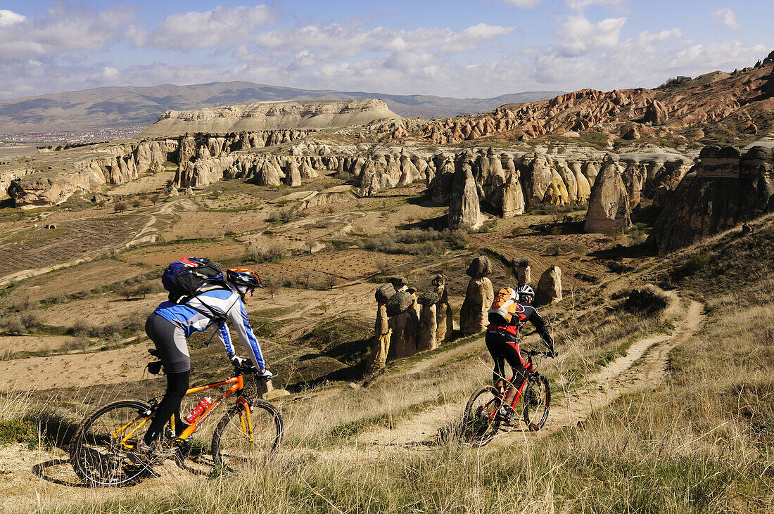 Mountain bikers near Cavusim, Göreme valley, Göreme, Cappadocia, Turkey