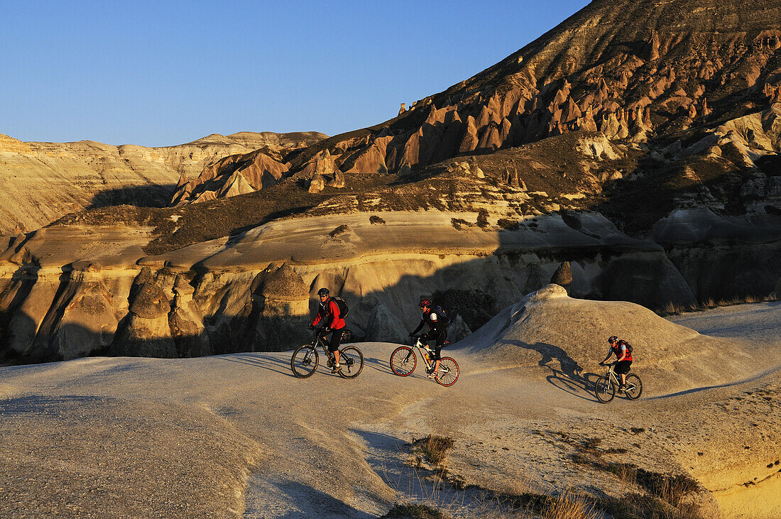 Mountain bikers in the Devrent Valley, Göreme, Cappadocia, Turkey