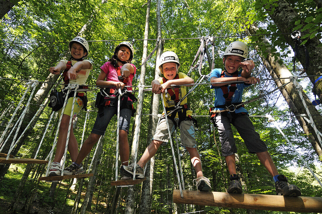 Children at high ropes course at Maserer Pass, Reit im Winkl, Chiemgau, Upper Bavaria, Bavaria, Germany, Europe