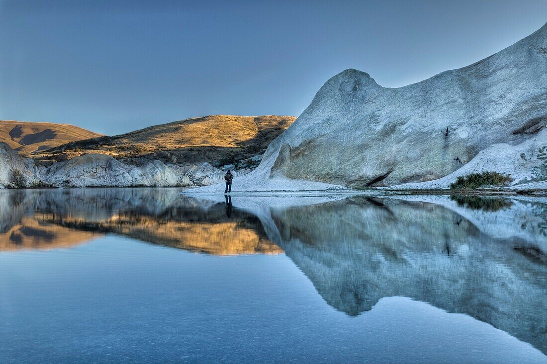 Trout fisherman, Blue lake reflection, dawn, St Bathan's, Central Otago
