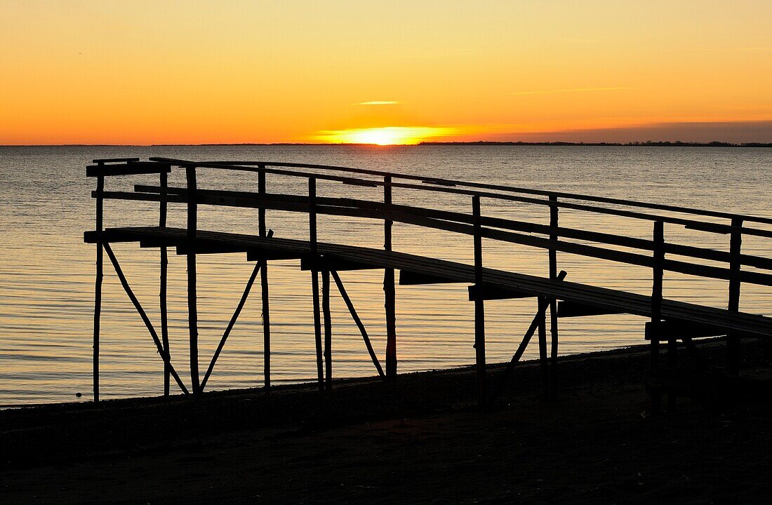 Wooden pier on Lake Winnipeg at dawn